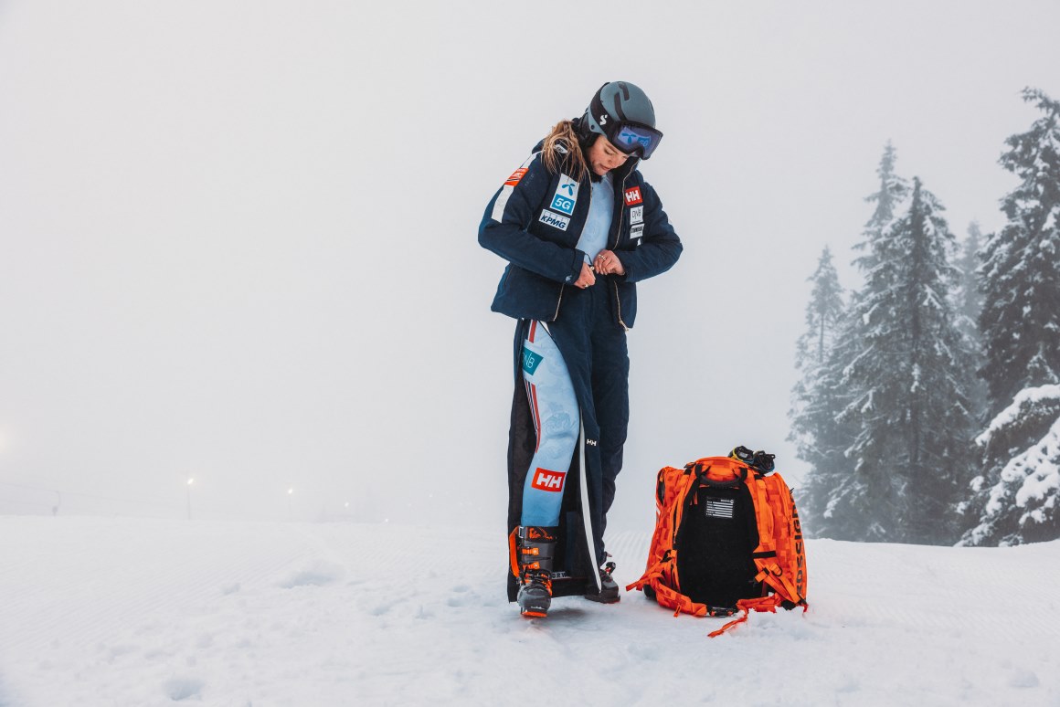 A Norwegian Alpine Team member stands on the mountain