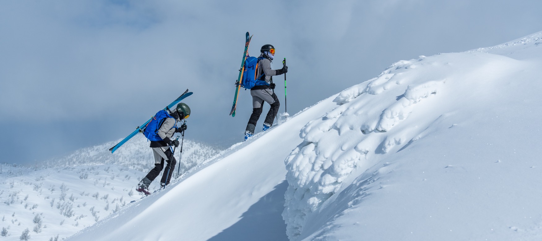 Man and woman ski touring in our Odin backcountry gear