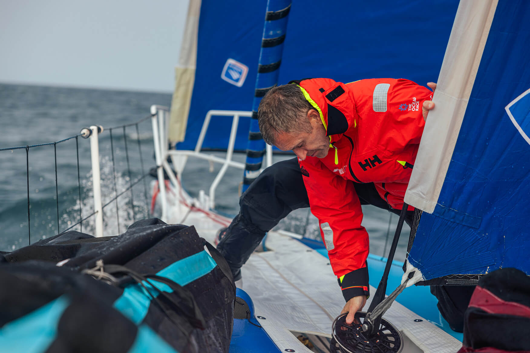 sailor at work on the deck of his boat