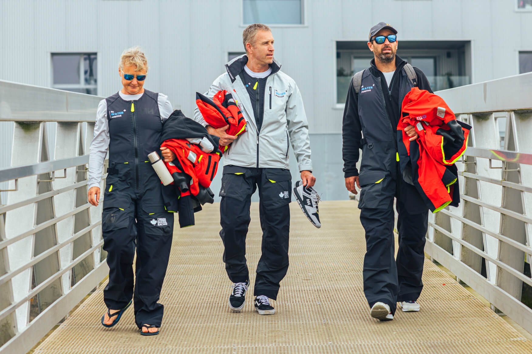 Crew of Canada Ocean Racing – Team Be Water Positive walking down the dock
