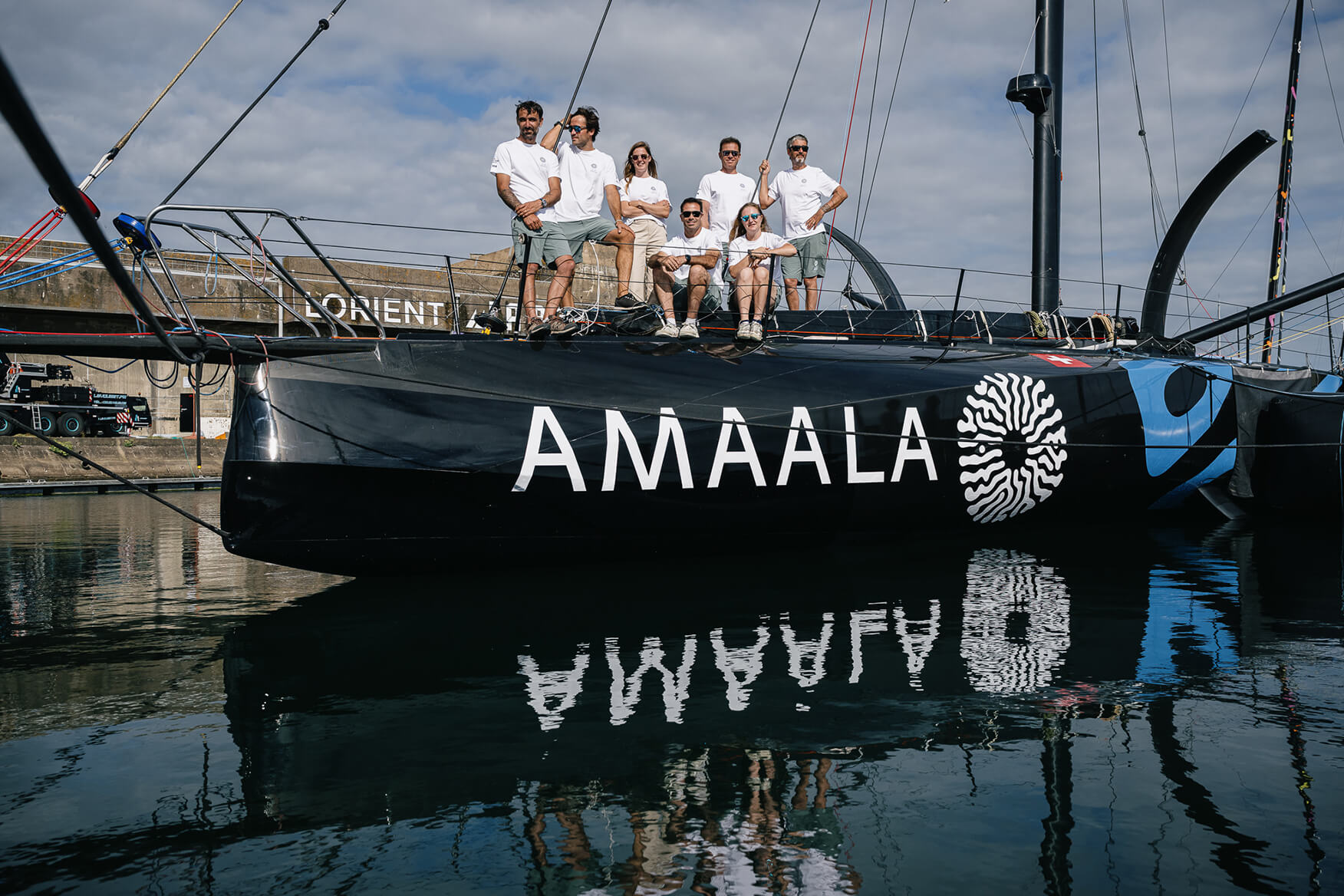 The crew of Team AMAALA sitting on the boat