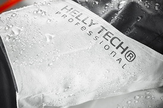 Close-up of water beading off the face fabric of a Helly Tech garment.