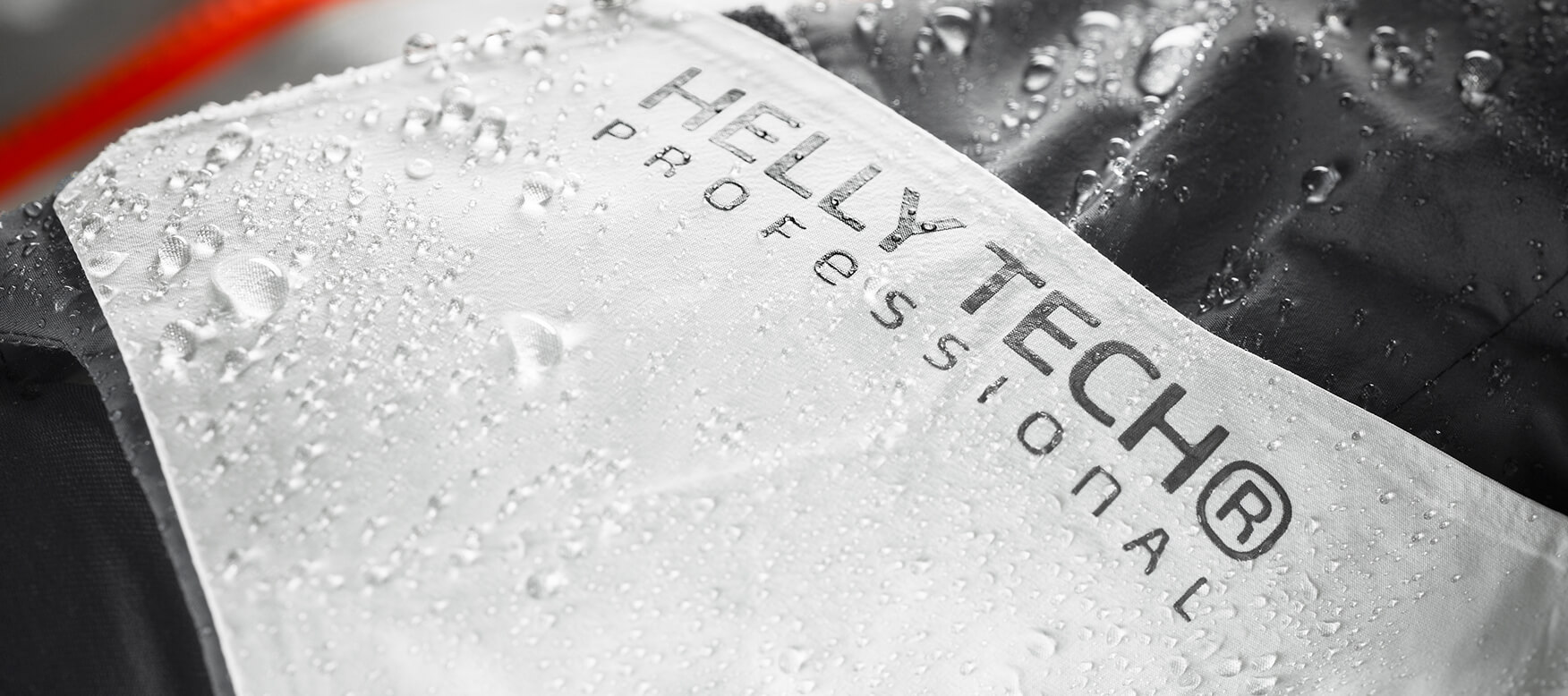 Close-up of water beading off the face fabric of a Helly Tech garment.